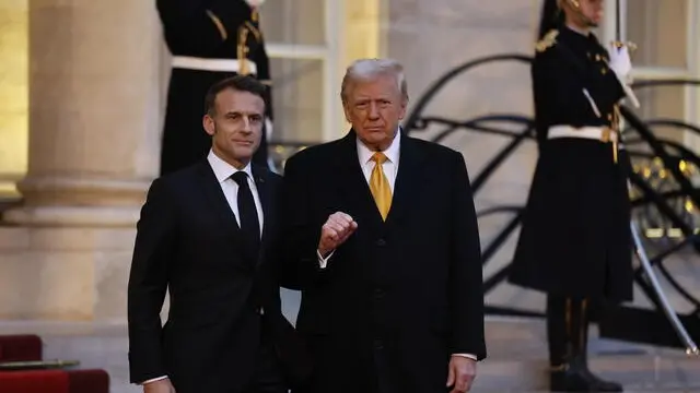 epa11762345 French President Emmanuel Macron (L) welcomes US president-elect Donald J. Trump at Elysee Palace prior the reopening ceremony of the Notre Dame de Paris Cathedral, in Paris, France, 07 December 2024. The Notre-Dame de Paris Cathedral reopens on 07 December after nearly six years of renovation work following its destruction by a fire on 15 April 2019. EPA/MOHAMMED BADRA