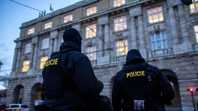 epa11040537 Police officers stand guard following a mass shooting at one building of the Charles University in central Prague, Czech Republic, 22 December 2023. According to the Czech Police President Martin Vondrasek, there are at least 14 people dead and 25 injured after the shooting at the Charles University on 21 December. According to Czech police the perpetrator was a 24 year-old Charles University student, who is also suspected of killing his father. EPA/MARTIN DIVISEK