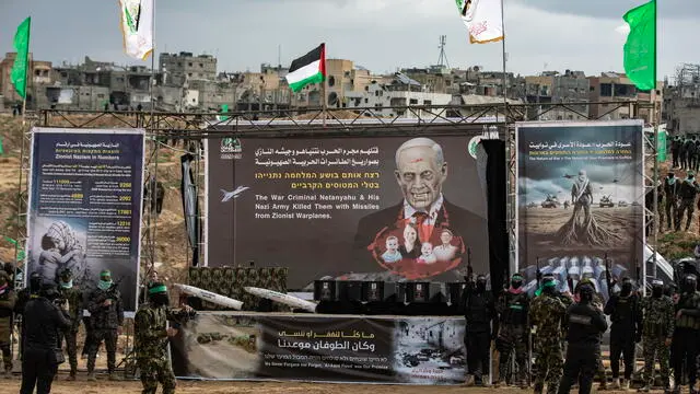 epa11909256 The coffins containing the bodies of Sheri Bibas, her two children, Ariel and Kfir, and Oded Lifshitz, sit on a stage before being handed over to the Red Cross by Hamas in Khan Yunis, southern Gaza Strip, 20 February 2025. Hamas was set to hand over the bodies of four Israeli captives, including that of youngest hostage Kfir Bibas, as part of the ongoing Gaza ceasefire deal. Hamas said in November 2023 that the two Bibas boys and their mother had been killed in an Israeli airstrike on Gaza. EPA/HAITHAM IMAD