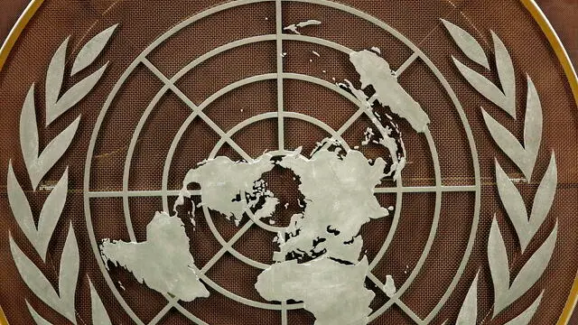 epa09479284 The logo of the United Nations is seen in the General Assembly hall before heads of state begin to address the 76th Session of the U.N. General Assembly in New York City, USA, 21 September 2021. EPA/EDUARDO MUNOZ / POOL