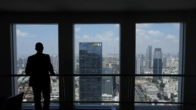 epa06933832 A man looks from the observation deck of the Azrieli Towers overlooking the skyline in Tel Aviv, Israel, 07 August 2018. Tel Aviv is the financial and technological center of the country. EPA/ABIR SULTAN