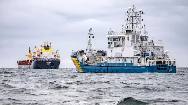 epa11856906 The Swedish Coast Guard vessel KBV033 (R) and the cargo ship Vezhen are anchored outside Karlskrona, Sweden, 27 January 2025, after a new cable break in the Baltic Sea. According to tracking sites, the Malta-registered ship Vezhen passed the area of the Latvian fiber cable that was damaged in the Swedish economic zone off Gotland on 26 January 2025. The Vezhen is under seizure while it is being investigated by Swedish authorities. EPA/JOHAN NILSSON SWEDEN OUT