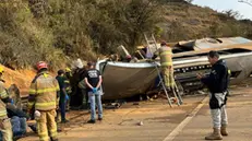 epa10810590 A handout photo made available by the Belo Horizonte Military Fire Department shows firefighters attend to a traffic accident, at kilometer 525 of the Fernao Dias national highway, within the metropolitan region of Belo Horizonte, Brazil, 20 August 2023. At least seven people died and 27 were injured in the early hours of 20 August as a result of a traffic accident involving a bus carrying fans of the Brazilian soccer club Corinthians. The number of deaths was confirmed by the Environmental Emergencies and Disaster Response Battalion of the Fire Department of the state of Minas Gerais (southeast), which provided relief work to the accident that occurred between the municipalities of Brumadinho and Igarape. EPA/Belo Horizonte Military Fire Dept. / HANDOUT HANDOUT EDITORIAL USE ONLY/NO SALES