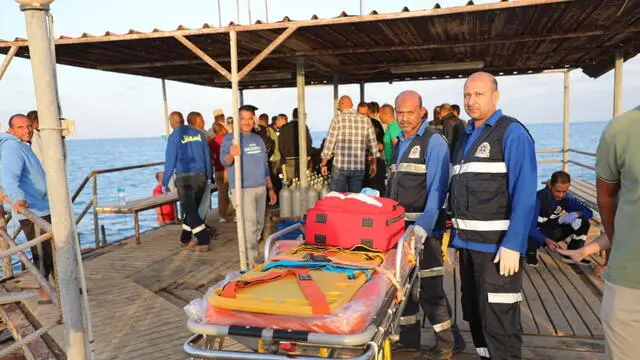 epa11740211 A handout picture made avaliable by Egyptian Press Center shows medics wait for possible survivors after a boat sank at a harbour in Marsa Alam, Red Sea Governorate, in Egypt 25 Novermber 2024. Red Sea Governor Major General Amr Hanafi reported that rescue efforts had successfully rescued 28 people from the tourist launch 'Sea Story' sinking accident north of Marsa Alam thus far. Searches are still underway to locate the other 17 passengers who have gone missing. EPA/HANDOUT/EGYPTIAN PRESS CENTER HANDOUT HANDOUT EDITORIAL USE ONLY/NO SALES