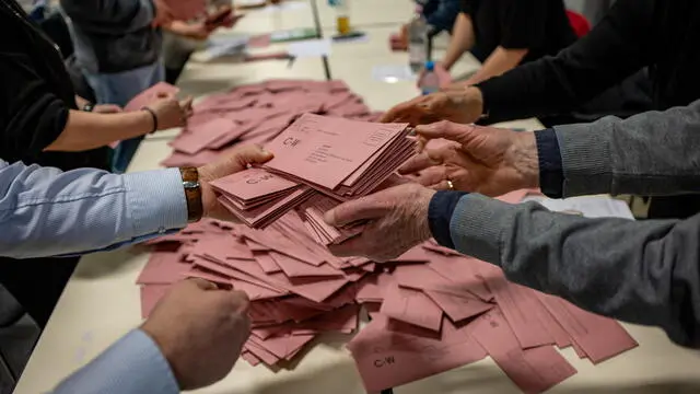 epa11918495 Election assistants prepare the vote count of postal ballots for the federal elections, in Berlin, Germany, 23 February 2025. About 60 million people are eligible to vote in the German elections for a new federal parliament, the 21st Bundestag. EPA/MARTIN DIVISEK