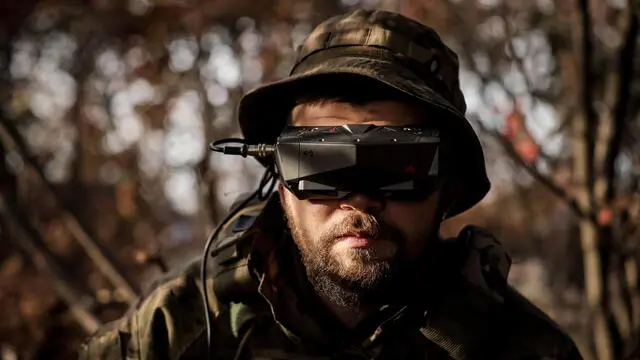 epa10952176 A serviceman of Separate 14th Regiment of Armed Forces of Ukraine, call-sign Spokiy, wears glasses to operate a FPV strike drone on the front line in Zaporizhia region, 27 October 2023 (issued 01 November 2023). The FPV (First Person View) drone is a compact device that operates within short distances of 5-20 km. It can transport various types of ammunition capable of destroying vehicles, personnel, and even armored vehicles, proceeding towards the target one-way while carrying the payload. Last year saw an escalation in the use of FPV (first person view) drones in the Russian war in Ukraine. Drones have become an economical and effective weapon that can save the lives of personnel during an attack or active defense by providing the ability to operate from protected positions. A single drone, that costs less than 1000 euros, can effectively destroy military vehicles and achieve closed targets. The production of these simple drones is straightforward, making them economical and widely available. EPA/OLEG PETRASYUK ATTENTION: This Image is part of a PHOTO SET