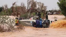 epa11561764 Members of the security forces use an outboard boat to move local residents to safety during floods in Niamey, Niger, 23 August 2024. In less than three months, floods have caused 217 deaths and 200 injuries in the desert country, and more than 350,000 people were affected, according to the military authorities. The flooding of rivers in Niger is due to the heavy rains that have been falling on the Sahel region since June. EPA/ISSIFOU DJIBO