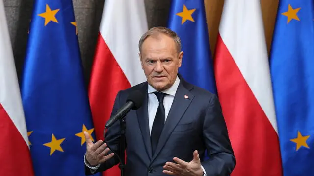 epa11902580 Polish Prime Minister Donald Tusk speaks to the media at a press briefing at Okecie airport in Warsaw, Poland, 17 February 2025. Tusk departs to Paris, where he will attend an informal meeting on the situation in Ukraine and security in Europe. EPA/PAWEL SUPERNAK POLAND OUT