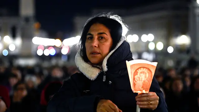 A faithful attends a Rosary prayer in St. Peter's Square for the health of Pope Francis, Vatican City, 02 March 2025. ANSA/RICCARDO ANTIMIANI