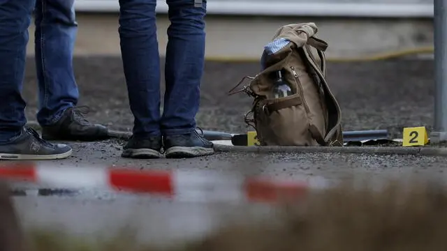 epa09706617 Weapons are seen near the crime scene at the Heidelberg University in Heidelberg, Germany, 24 January 2022. A man with long-barrelled firearm had opened fire at students in an auditorium and injured four people before shooting himself dead, Mannheim police said. EPA/RONALD WITTEK