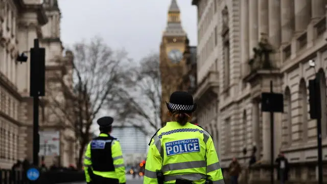 epa11865912 Police officers stand guard in a street in London, Britain, 31 January 2025. The British government has announced an additional 100 million pounds into neighbourhood policing in an effort to boost numbers on the ground. However, police forces have warned of a gap in funding and may need to cut officer numbers. EPA/ANDY RAIN