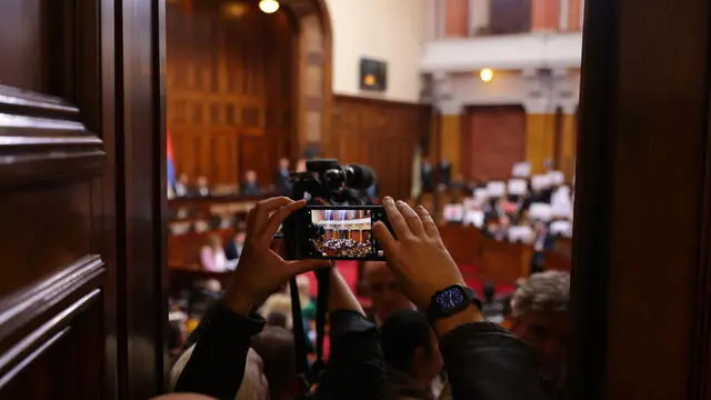 epa11939615 A videographer films during the first session of the First Regular sitting of the National Assembly in 2025 in the Serbian parliament in Belgrade, Serbia, 04 March 2025. Opposition members of parliament staged a protest demanding government accountability after fifteen people lost their lives in the collapse of the Novi Sad Railway Station canopy in November 2024. EPA/ANDREJ CUKIC