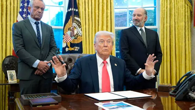 epa11924689 US President Donald Trump (C) speaks to reporters alongside Health and Human Services Secretary Robert F. Kennedy Jr. (L) and Secretary of Commerce Howard Lutnick (R) as he signed executive orders in the Oval Office of the White House in Washington, DC, USA, 25 February 2025. EPA/YURI GRIPAS / POOL