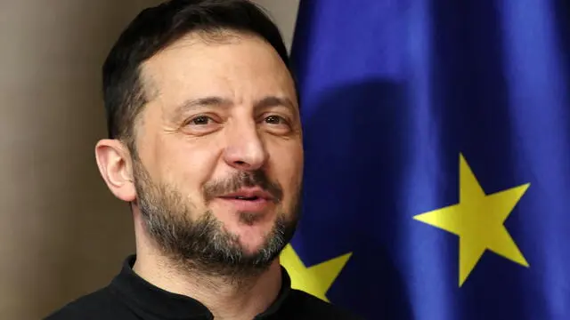 epa11897793 Ukrainian President Volodymyr Zelensky stands next to a flag of the European Union as he arrives to meet with the German Chancellor at the 61st Munich Security Conference (MSC) in Munich, Germany, 15 February 2025. High-level international decision-makers meet at the 61st Munich Security Conference in Munich from 14 to 16 February 2025 during their annual meeting to discuss global security issues. EPA/Sean Gallup / POOL