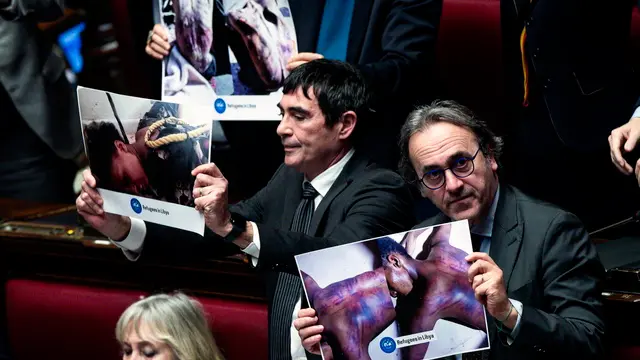 epa11876802 Secretary of Italian Left (Sinistra Italiana) party Nicola Fratoianni (L), and co-spokesperson of Green Europe (Europa Verde) party Angelo Bonelli (R) hold photos depicting tortured people in Libya, during a government briefing over the case of Libyan General Osama Najim Almasri, at the Lower House in Rome, Italy, 05 February 2025. On 21 January the Italian government released and repatriated Almasri after a brief detention over an International Criminal Court (ICC) arrest warrant. The general is wanted by the ICC over allegations of war crimes and crimes against humanity. EPA/ANGELO CARCONI