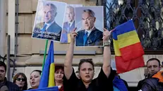 epa11952312 Calin Georgescu supporters wave placards and national flags while shouting slogans during a protest in front of the Central Elections Bureau in Bucharest, Romania, 09 March 2025. Georgescu, the independent candidate who won the first round of Romania's annulled presidential elections, registered his candidacy at the Central Elections Bureau on 07 March 2025. Former independent presidential candidate Georgescu was questioned by prosecutors on 26 February 2025 as part of an investigation into election campaign fraud, including actions against the constitutional order and false statements about campaign financing. A judge from the Prosecutor General's Office imposed a judicial control measure, which Georgescu appealed. Romanians will vote in the first round of the presidential elections on 4 May 2025. EPA/ROBERT GHEMENT