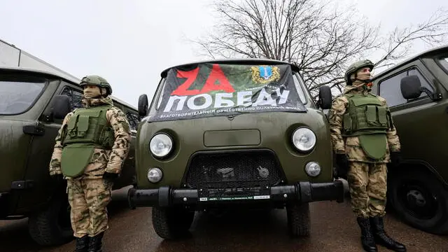 epa11859783 Russian servicemen stand near off-road vehicles during the sending off of the 133rd humanitarian convoy gathered by the Russian Communist Party, destined for the Russian army and residents of the Kursk, Donetsk, and Luhansk regions, at the Lenin State Farm, outside Moscow, Russia, 29 January 2025. According to Russian Communist Party (CPRF) leader Gennady Zyuganov, his party has sent more than 23 thousand tons of various cargo to the Russian army and civilians of the Donetsk and Luhansk republics since 2014. EPA/SERGEI ILNITSKY