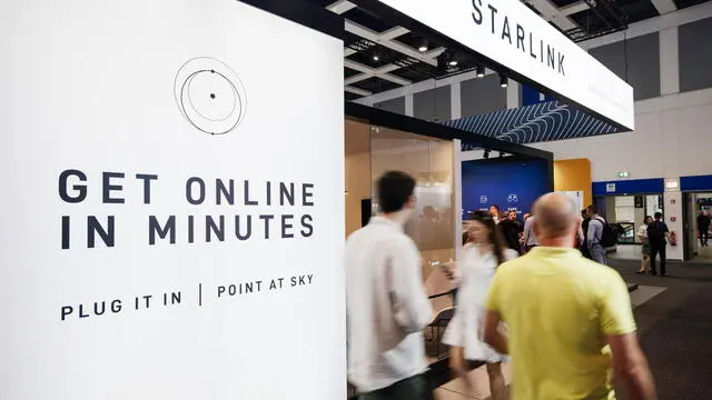 epa11588980 Visitors pass by the booth of Starlink by SpaceX during the opening day of the 100th IFA trade fair in Berlin, Germany, 06 September 2024. The IFA, the world's largest trade show for consumer electronics and home appliances, celebrates its 100th anniversary and takes place from 06 to 10 September 2024. EPA/CLEMENS BILAN