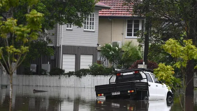 epa11952933 Flooded houses are seen in Oxley, in Brisbane, Australia, 10 March 2025. A cyclone has been downgraded to a tropical low but its impact is still being felt with a region reeling from major flooding with more wild weather forecast. EPA/JONO SEARLE AUSTRALIA AND NEW ZEALAND OUT