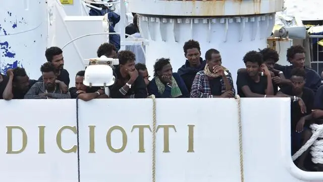 Migrants wait to disembark from Italian Coast Guard ship Diciotti in the port of Catania, Italy, 24 August 2018. The vessel arrived between Sunday and Monday with 177 migrants on board, but the Italian Interior Ministry denied them to disembark, calling EU member states to find a solution on how to distribute them. On 22 August, 27 unaccompanied minors were let off from the ship, assisted by Red Cross, UNHCR and Save the Children. ANSA/ORIETTA SCARDINO