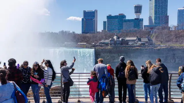 epa11264790 People view Niagara Falls from Terrapin Point in Niagara Falls, New York, USA, 07 April 2024. A total solar eclipse will be visible on 08 April 2024 across North America. Thousands are expected to view the eclipse from the iconic Niagara Falls area. EPA/SARAH YENESEL