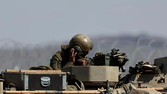 epa11934942 An Israeli tank at the fence along the buffer zone between Israel and Syria, near Quneitra, in the Israeli-annexed Golan Heights, 02 March 2025. Israelâ€™s prime minister and defense minister have instructed the IDF to prepare to defend the Druze community of Jaramana, in the suburbs of the Syrian capital Damascus, following local clashes with the new Syrian government forces. EPA/ATEF SAFADI