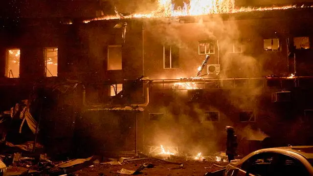 epa11857524 Ukrainian rescuers work at the site of a drone strike on a private factory in Kharkiv, northeastern Ukraine, 28 January 2025, amid the Russian invasion. A fire broke out in a private factory in Kharkiv after being hit by a Russian unmanned aerial vehicle overnight, covering an area of about 1,500 square meters. No casualties were reported in the attack, according to the State Emergency Service of Ukraine (SESU). EPA/SERGEY KOZLOV