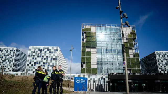 epa11958038 Police officers stand in front of the the International Criminal Court (ICC), as supporters and opponents of former Filipino President Rodrigo Duterte gather after his arrest in The Hague, Netherlands, 12 March 2025. Duterte was arrested on 11 March in Manila, following a warrant from the ICC which is investigating his war on drugs campaign that resulted in thousands of cases of alleged extra-judicial killings. EPA/BART MAAT