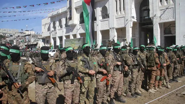 epa11851280 Hamas militants gather in the center of Gaza City ahead of the release of four Israeli hostages in the Gaza Strip, 25 January 2025. The four Israeli hostage soldiers Liri Albag, Naama Levy, Karina Ariev, and Daniella Gilboa, were taken hostage from an intelligence outpost near the Israeli Gaza border during the Hamas-led attack on 07 October 2023. Israel and Hamas implemented the first phase of a hostage release and ceasefire deal on 19 January 2025. EPA/MAHMOUD ZAKI