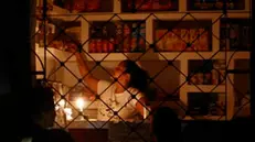 epa11668937 A woman works in a store during a blackout in Havana, Cuba, 18 October 2024 (issued 19 October 2024). The power supply has completely collapsed due to a power plant failure on 18 October 2024. After this initial nationwide blackout, the power went out again early 19 October 2024 all over the country. EPA/Ernesto Mastrascusa