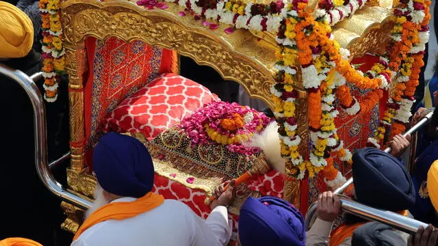 epa08947987 Sikh devotees carry Guru Granth Sahib, the holy book of Sikhism, in a special golden palanquin during a religious procession at the Golden Temple, the holiest od Sikh places on the eve of the birth anniversary of the tenth Sikh Guru, Gobind Singh, in Amritsar, India, 19 January 2021. Guru Gobind Singh was the tenth and the last Sikh Guru who initiated the special order or sect of the Sikhs called the Khalsa Panth. EPA/RAMINDER PAL SINGH