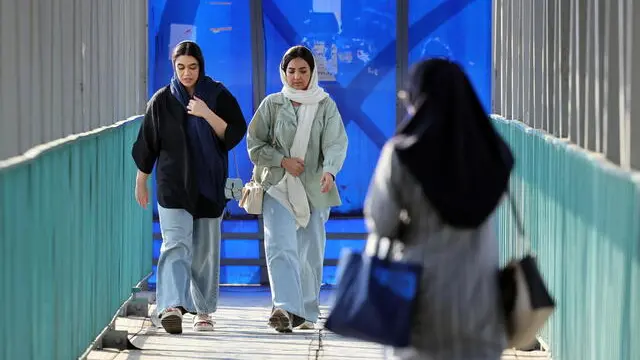 epa11605790 Iranian women walk in a street in Tehran, Iran, 15 September 2024, on the second anniversary of protests following Mahsa Amini's death. Mahsa Amini, a 22-year-old Iranian woman, was arrested in Tehran on 13 September 2022 by the police unit responsible for enforcing Iran's strict dress code for women. She fell into a coma while in police custody and was declared dead on 16 September 2022. Her death led to anti-government protests worldwide. EPA/ABEDIN TAHERKENAREH