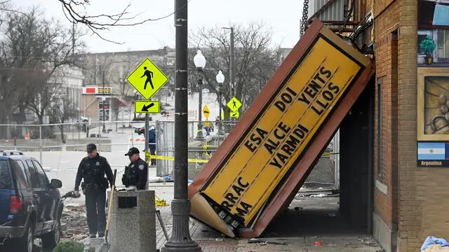 epa10554116 Investigators look over the Apollo Theatre following a tornado in Belvidere, Illinois, USA, 01 April 2023. A man was killed and more than two dozen injured after the roof of the Apollo Theatre collapsed on 31 March evening, according to fire officials. Numerous tornadoes were confirmed across a huge area of the center of the US a week after at least 25 people were killed in Mississippi after a tornado and severe weather outbreak. EPA/MATT MARTON