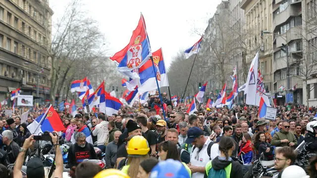 epa11965648 Protesters wave Serbian flags during the student-led rally in Belgrade, Serbia, 15 March 2025. University students staged a protest, demanding accountability after fifteen people lost their lives in the collapse of the Novi Sad Railway Station canopy in November 2024. The station building, which had been renovated and reopened in July 2024, was undergoing further renovations shortly before the collapse. EPA/ANDREJ CUKIC