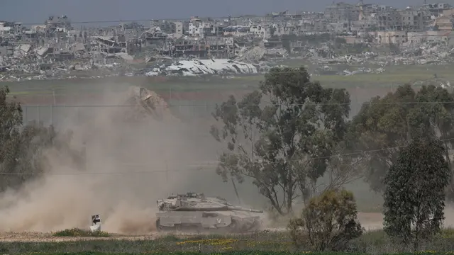 epa11971169 An Israeli tank patrols along the border with the Gaza Strip, as seen from an undisclosed location in Israel, 18 March 2025. The Israeli forces on 18 March confirmed they were carrying out 'extensive strikes' on targets in the Gaza Strip, following an Israeli prime minister's statement which ended the ceasefire in place since 19 January. According to provisional figures released by the Palestinian Health Minister, more than 400 people were killed in a series of overnight strikes in the Gaza Strip. EPA/ATEF SAFADI