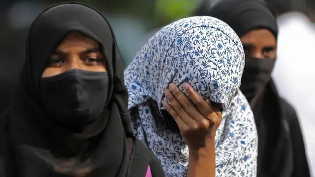 epa09826708 Indian Muslim women wearing hijab and niqab walk down after attending classes in Bangalore, India 15 March 2022. The Karnataka State High Court upheld the hijab ban and dismissed pro hijab petitions in educational institutions and the high court also said that wearing the hijab is not an essential religious practice of Islam. Meanwhile, prohibitory orders under Section 144 have been imposed in view of the Hijab row verdict in few district and Bangalore until 19 March. EPA/JAGADEESH NV