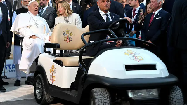 Pope Francis (L) and Italy's Prime Minister Giorgia Meloni leave after a family photo with G7 heads of States and heads of delegation of Outreach countries at Borgo Egnazia resort during the G7 Summit hosted by Italy in Savelletri (Brindisi), southern Italy, 14 June 2024. ANSA/ETTORE FERRARI