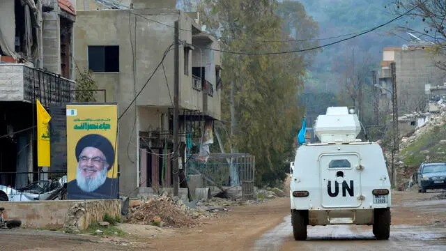 epa11947126 United Nations Interim Force in Lebanon (UNIFIL) soldiers patrol past the rubble of destroyed buildings in the village of Houla, southern Lebanon, 07 March 2025. A ceasefire agreement between Israel and Hezbollah went into effect 26 November 2024. EPA/WAEL HAMZEH