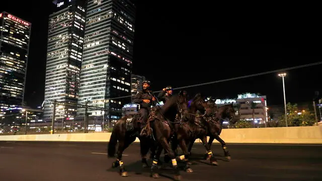 epa10758633 Israeli mounted police patrol along Ayalon highway as anti-government protesters try to block it during a protest against the Israeli justice system reform in Tel Aviv, Israel, 20 July 2023. Protesters called for a new 'night of resistance' all around the country, in response to the Israeli government plans to pass an unpopular justice reform, which the protesters fear will weaken the independence of the Israeli Supreme Court. In the absence of a constitution for the state of Israel, the Supreme Court plays a major role in maintaining the checks and balances between the legislative, the judiciary and the executive bodies of the state. EPA/ATEF SAFADI