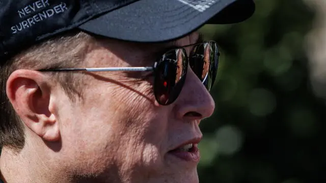 epa11957033 US President Donald Trump is reflected in the sunglasses of Tesla CEO and Senior Advisor to the President of the United States Elon Musk, as he speaks in front of Tesla vehicles at the White House in Washington, D.C.USA, 11 March 2025. President Trump has said he will buy a Tesla to support Tesla and Elon Musk after recent attacks on Tesla charging stations and calls for boycotts of Tesla products. EPA/SAMUEL CORUM / POOL