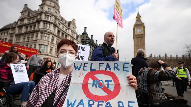 epa11989525 Protesters demonstrate against disabilty and welfare cuts during the announcement of the Spring Statement outside parliament in London, Britain, 26 March 2025. The Spring Statement is a series of economic announcements made by the Treasury to Parliament. EPA/ANDY RAIN