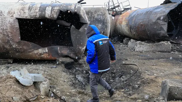 epa11971906 A worker inspects the damage at the AES Group private oil refinery the day after a Russian shock drone attack, in Merefa, Kharkiv region, Ukraine, 18 March 2025. Kharkiv investment and industrial group AES Group confirmed the destruction of the oil refinery in Merefa after about 20 drones were launched at the enterprise. That was the fourth attack on the enterprise since February 2022, company officials said. EPA/SERGEY KOZLOV