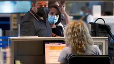 epa09412357 A masked couple wait in front of a check-in desk, after handling their electronic tickets and Covid digital certificates, at the departures terminal of the Henri-Coanda International Airport, in Otopeni, Romania, 13 August 2021. Starting Friday, August 13, the COVID Digital Certificate, a proof of vaccination against Covid-19, passing through the disease or the negative result of an RT-PCR coronavirus test, is the only document that allows entry into EU countries. The obligation to present the digital certificate refers only to the countries that require such documents at the border as well as the return to Romania from yellow and red list countries, according to the National Association of Agencies of Tourism. Crossing borders is possible without the existence of these certificates, but in compliance with the national quarantine rules of each state. The COVID digital certificate can be presented at customs both in print and on the phone, the validation being done using the QR code, which is scanned at the border. EPA/ROBERT GHEMENT