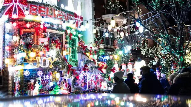 epa11039500 People tour the elaborate Christmas decorations put up annually on houses in the Dyker Heights neighborhood of Brooklyn, New York, USA, 20 December 2023. The neighborhood has been known for its expansive Christmas displays as a result of a tradition generally traced back to holiday decorations put up in 1986 by resident Lucy Spata. EPA/JUSTIN LANE