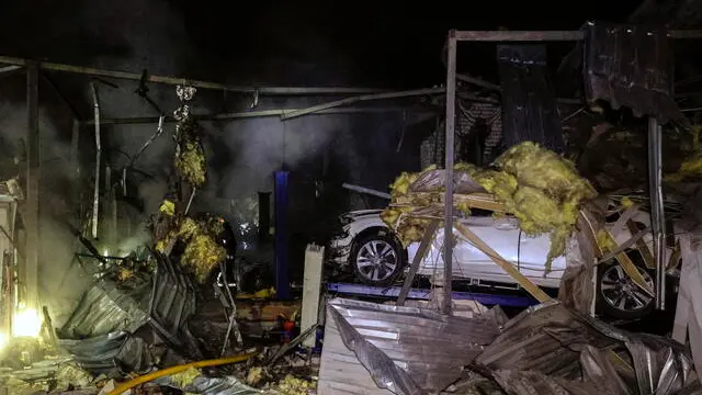 epa12019714 Ukrainian rescuers work at the site of a drone attack in Kharkiv, Ukraine, late 08 April 2025 (issued 09 April 2025), amid the ongoing Russian invasion. According to the State Emergency Service, at least two people were injured in the attack. EPA/SERGEY KOZLOV