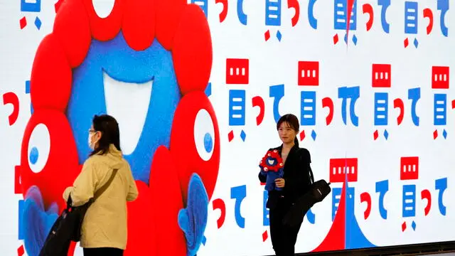 epa12020336 A woman holds a Myaku-Myaku puppet, the official mascot of the 'Expo 2025 Osaka, Kansai, Japan', during the media day ahead of the expo's opening, in Osaka, western Japan, 09 April 2025. The World Expo 2025 will open to the public on 13 April and will run until 13 October 2025 under the theme 'Designing Future Society for Our Lives'. EPA/FRANCK ROBICHON