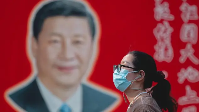 epaselect epa12002803 A woman walks in front of a portrait of Chinese President Xi Jinping in Shanghai, China, 01 April 2025. US President Trump is set to announce new tariffs on April 02, dubbed 'Liberation Day.' These tariffs will apply to neighboring countries Canada and Mexico, as well as imposing two 10 percent tariffs on China. EPA/ALEX PLAVEVSKI