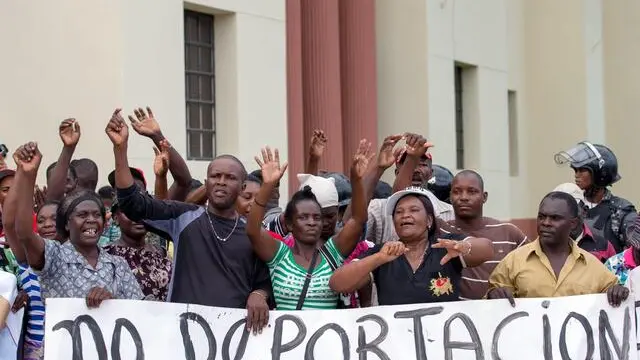 epa04805796 Migrants from Haiti, who work for sugar cane companies, protest outside the National Palace in Santo Domingo, the Dominican Republic, 17 June 2015. Banner reading 'no deportation'. The process of registration part of the regularization plan for Foreigners in the country, ends on 17 June 2015. Those who did not complete their registration process will be repatriated. The measure will affect mostly Haitians living in the country. EPA/ORLANDO BARRIA