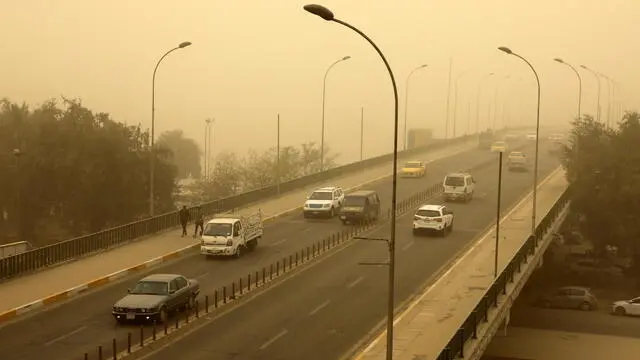 epa09885474 Vehicles transit at the al-Sinak bridge shrouded in heavy dust in central Baghdad, Iraq, 12 April 2022. The dust storm sent hundreds of people with respiratory problems to Baghdad's hospitals and reduced visibility in the city, making driving difficult on the roads. EPA/AHMED JALIL