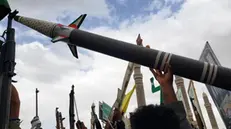epa12039051 Houthi supporters hold up a mock missile during a protest against US airstrikes on Houthi positions, in Sana'a, Yemen, 18 April 2025. Thousands of Houthi supporters took to the streets of Sana'a to protest against the US airstrikes which targeted since mid-March the Houthis-held positions in several cities of Yemen. The Houthis have launched 78 attacks on Israeli territory and US military vessels in the seas around Yemen since 15 March 2025, using 171 drones and ballistic and winged missiles, the Houthis' leader Abdul-Malik al-Houthi has said in a televised speech. EPA/YAHYA ARHAB
